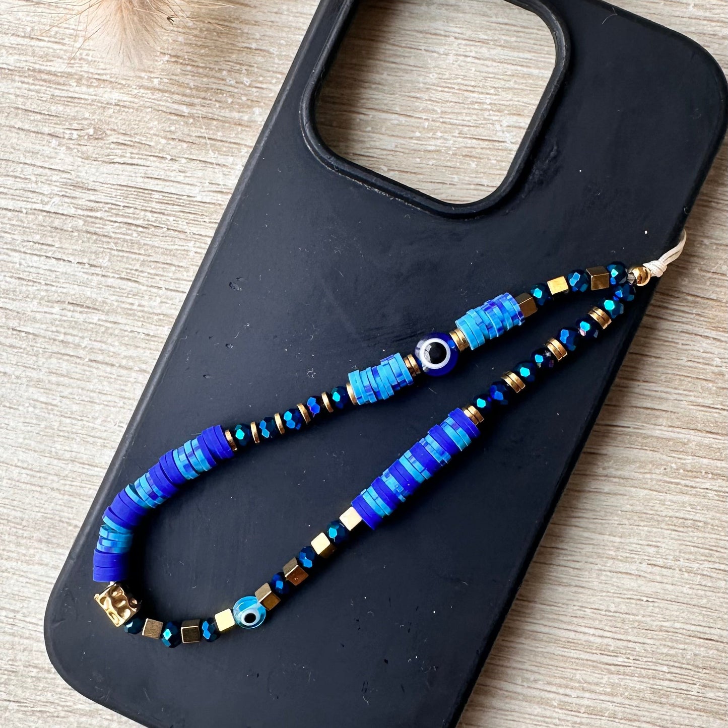 Grigri de téléphone cristal et oeil